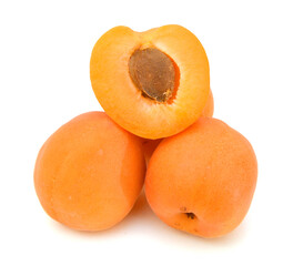 fresh yellow plums and a cut one on a white background