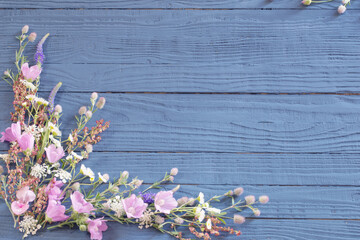 beautiful summer flowers on dark blue wooden background