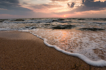 beautiful sunrise over the blue sea. meeting a new day. marine background. summer time. beautiful nature. bright rays of the sun. waves on the beach. © Vadym