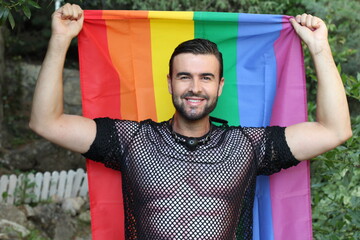 Very cute gay man holding the rainbow flag 