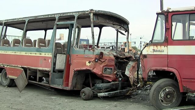 Old Crushed Passenger Bus in a Scrapyard in the Outskirts of Buenos Aires, Argentina.