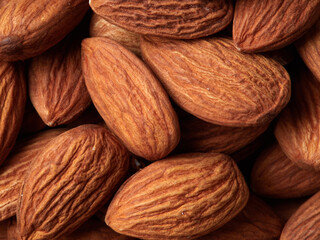 Almond in a bowl on wooden background with copy space