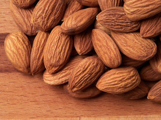Almond in a bowl on wooden background with copy space
