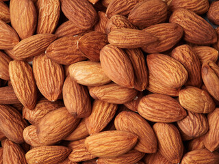 Almond in a bowl on wooden background with copy space