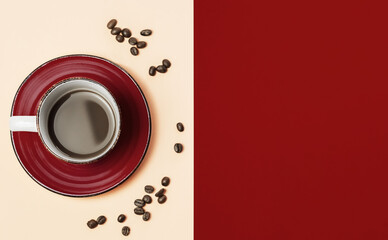 Top view of coffee cup with coffee and coffee beans on red and beige background. Color block, concept for background advertising with copy space.