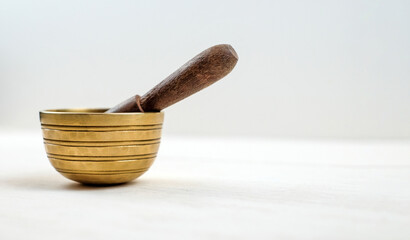Tibetian singing bowl on white wooden background with copy space