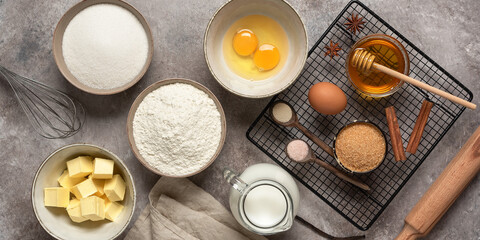 Obraz na płótnie Canvas Baking background banner. Baking ingredients: flour, eggs, sugar, butter, milk and spices. Top view.