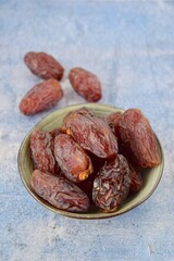 Fresh raw organic Medjool dates on blue background, selective focus