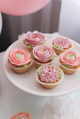 Pink cakes and pink balloons welcome guests to the party