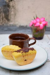 Kue Pukis, Traditional Javanese half-moon shaped pancakes. made from flour, eggs, yeast and coconut milk. Served with cup of tea
