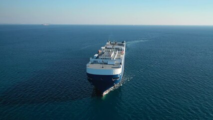 Aerial drone video of huge car carrier ship RO-RO (Roll on Roll off) cruising in Mediterranean deep blue ocean sea