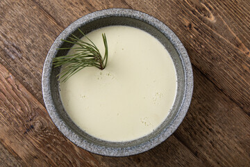 Vanilla dessert in rustic grey bowl on wooden table