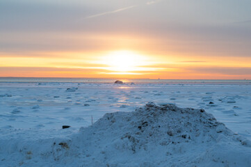 Sunset at frozen sea
