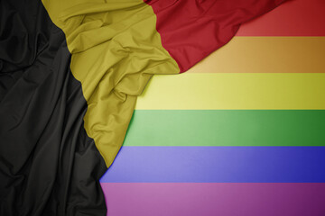 waving national flag of belgium on a gay rainbow flag background.