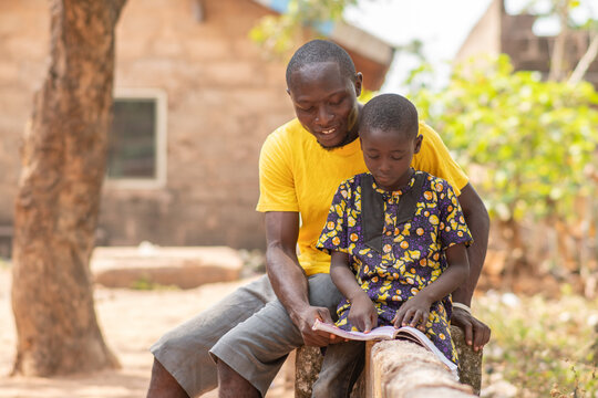 African Man Teaching A Child, Helping With Home Work