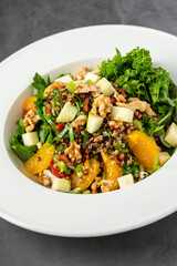 quinoa salad with walnuts, oranges and kale leaves