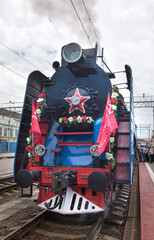   Passengers sit in cars, driven by a steam locomotive P 36 