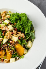 quinoa salad with walnuts, oranges and kale leaves