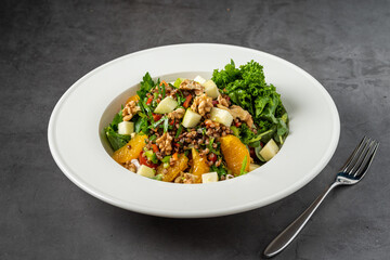 quinoa salad with walnuts, oranges and kale leaves