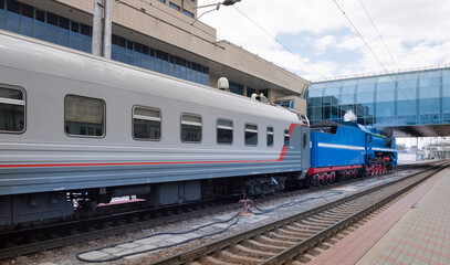 Fototapeta na wymiar The departure of a passenger train with a steam locomotive P 36 