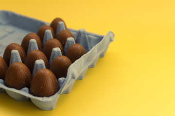 Chocolate eggs in the egg box for celebrating Easter.