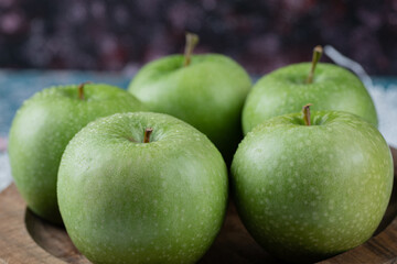 Apples being served in a round wooden plate