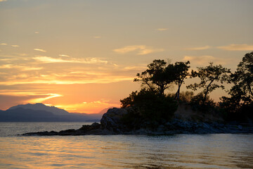 Fototapeta na wymiar Silhouetted trees at sunset, Tent Island, Gulf Islands, British Columbia, Canada