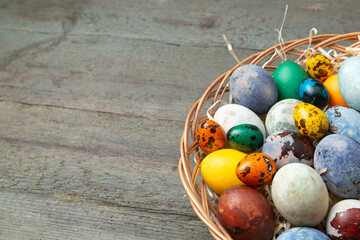 Colorful Easter eggs on a wooden background. Easter postcard with space for text. 