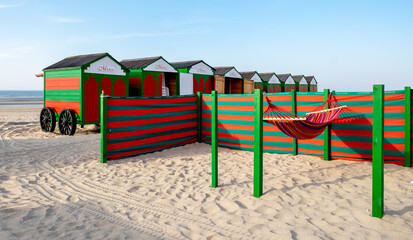Vintage green and red hammock, windbreaker and beach huts