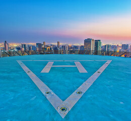 Helipad shot for a city and buildings at sunset