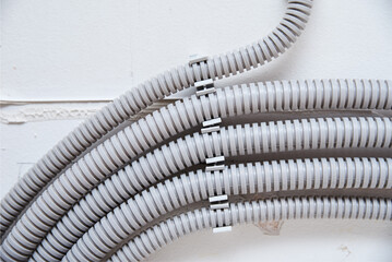 Electric cable corrugated on ceiling. Cable laying ceiling