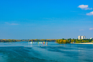 Many yachts at the river Dnieper on autumn in Kremenchug, Ukraine. Sailing regatta