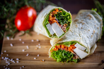 Vegetarian wrap sandwich on wooden background