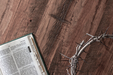 Crown of thorns and bible on wood