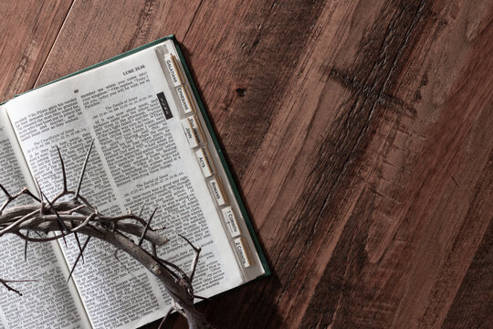 Crown of thorns and bible on wood