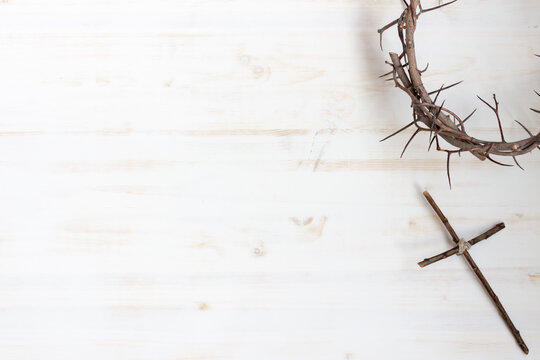 Crown of thorns and cross on white wood background with copy space - Powered by Adobe