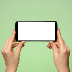 Smartphone horizontally with a blank screen in a woman's hand.