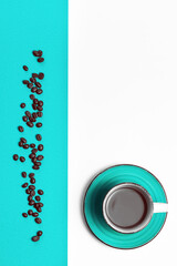 Top view of coffee cup with coffee and coffee beans on blue and white background. Color block. Close-up, copy space.