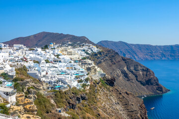 Fototapeta na wymiar Rocky Caldera of Santorini and the Colorful Buildings in Oia