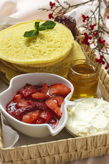 Homemade traditional moroccan baghrir with honey strawberries and mint from above