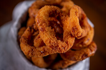 Onion rings snacks in a wooden background
