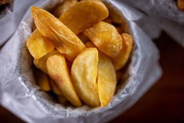 Fried potatoes snacks in a wooden background