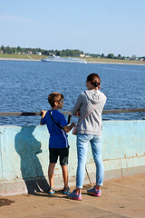 Fototapeta na wymiar Tourist family mother and son on the ferry across the Volga river in Russia