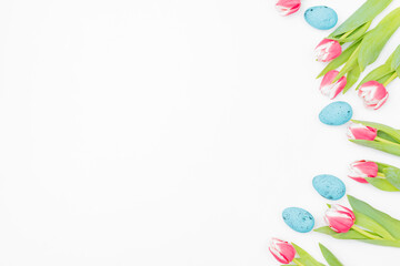 Flat lay easter composition with pink tulips and eggs on white background