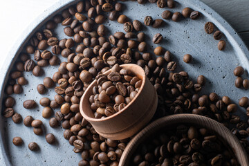 Brown roasted coffee beans falling on pile. Represent breakfast, energy, freshness or great aroma,Flying on dark background with copy space, close-up