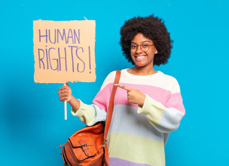 young pretty afro woman protesting with human rights banner