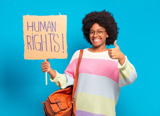 young pretty afro woman protesting with human rights banner