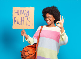 young pretty afro woman protesting with human rights banner