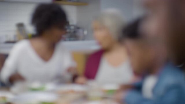 Family Around a Table Eating Dinner With Each Other