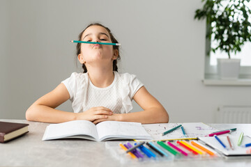 education and school concept - smiling little student girl with many books at school